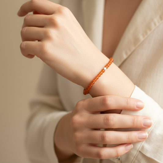 A woman wearing a 4mm Carnelian Elastic Beaded Energy Bracelet.