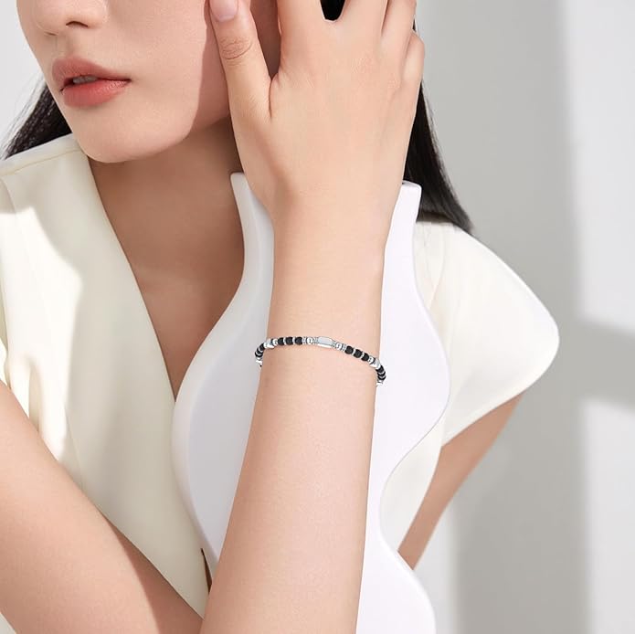 A woman wearing an adjustable boho style black obsidian bracelet