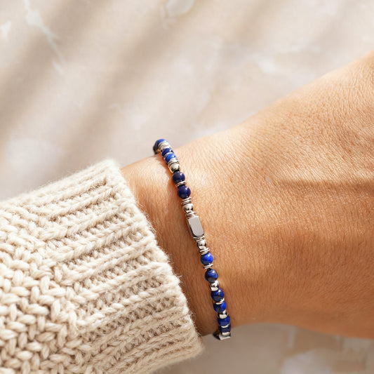 A woman wearing an adjustable boho style Lapis Lazuli energy bracelet.