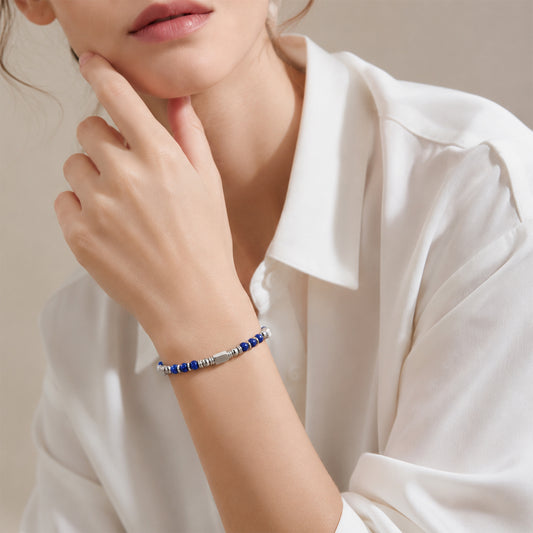 A woman wearing an adjustable boho style Lapis Lazuli energy bracelet.