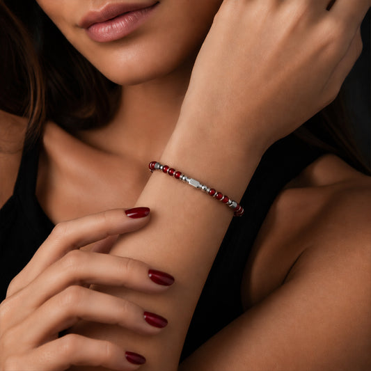 A woman wearing an adjustable boho style Red Agate energy bracelet
