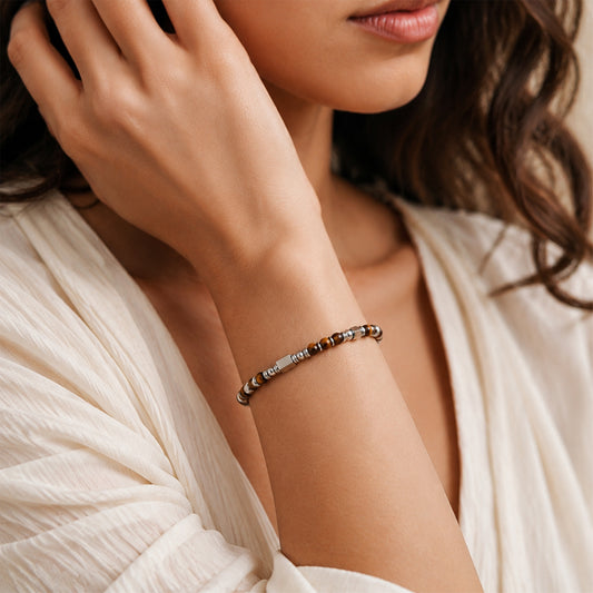 A woman wearing an adjustable boho style Tiger's Eye energy bracelet