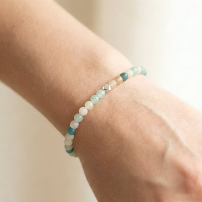 A woman wearing a 4mm Amazonite Elastic Beaded Energy Bracelet.