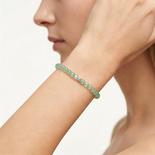 A woman wearing a 4mm Green Aventurine Elastic Beaded Energy Bracelet.