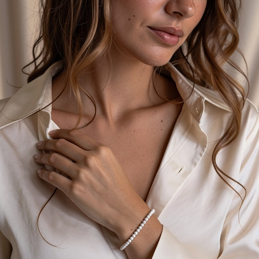 A woman wearing a 4mm Howlite Elastic Beaded Energy Bracelet.