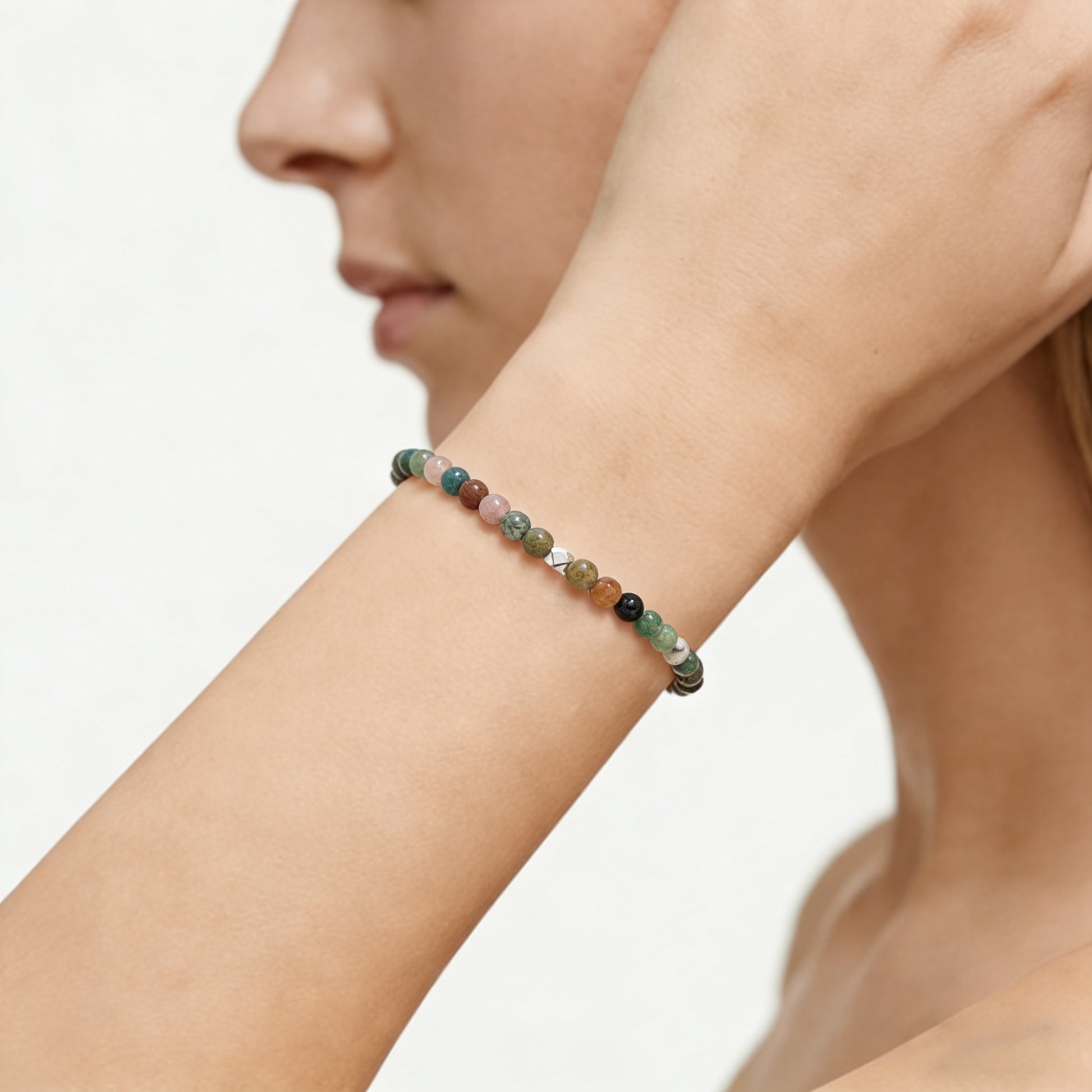 A woman wearing a 4mm India Agate Elastic Beaded Energy Bracelet.