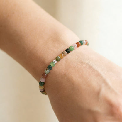 A woman wearing a 4mm India Agate Elastic Beaded Energy Bracelet.