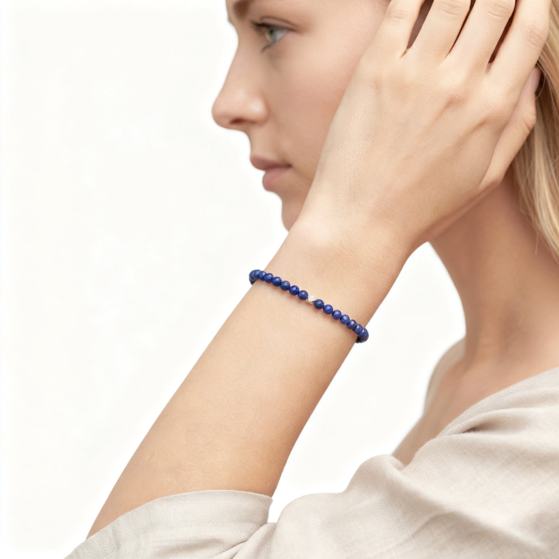 A woman wearing a 4mm Lapis Lazuli Elastic Beaded Energy Bracelet.