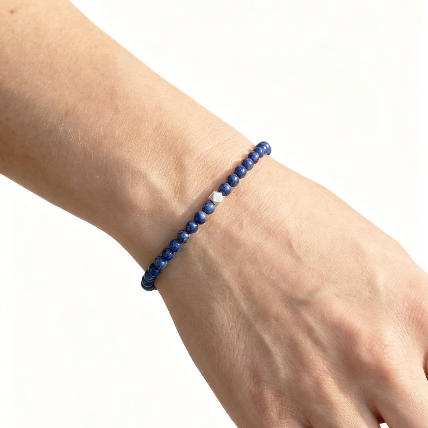 A woman wearing a 4mm Lapis Lazuli Elastic Beaded Energy Bracelet.