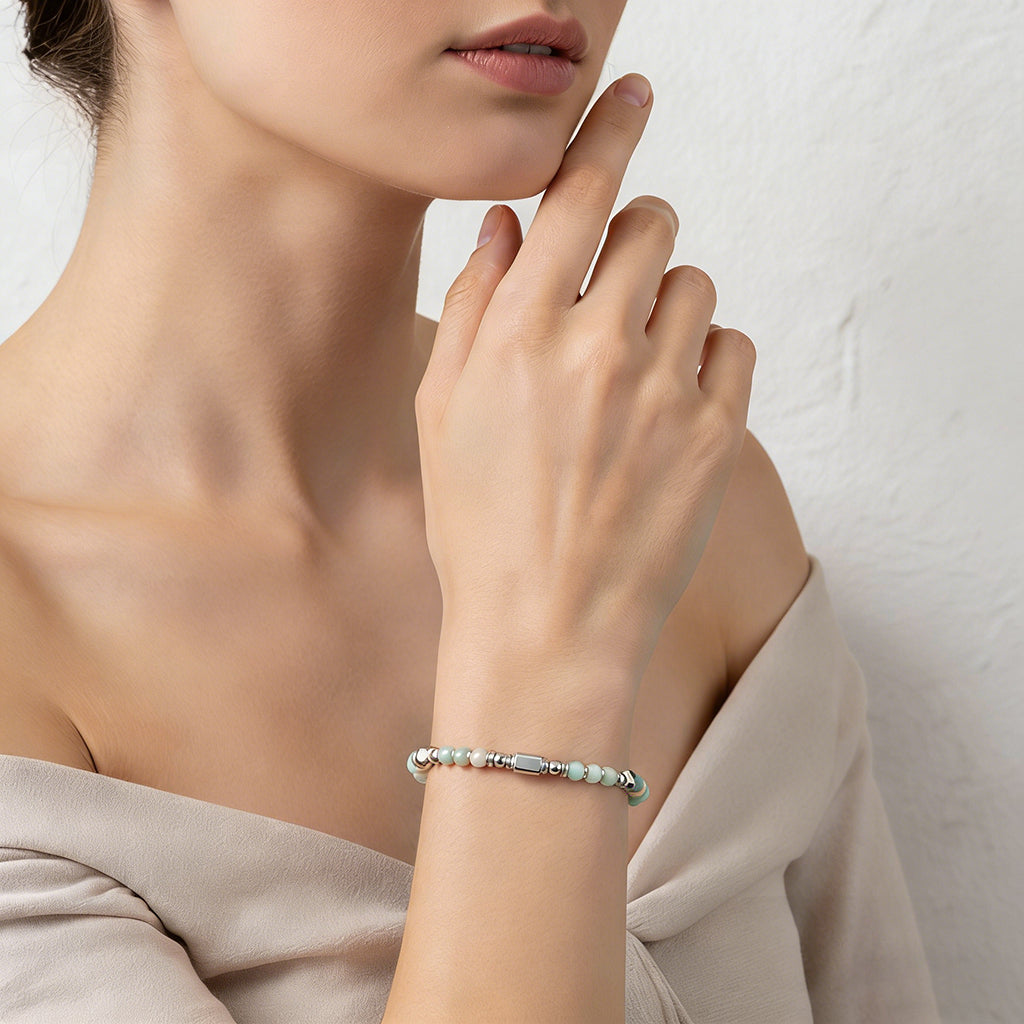 A woman wearing an adjustable boho style Amazonite energy bracelet.