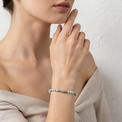 A woman wearing an adjustable boho style Amazonite energy bracelet.
