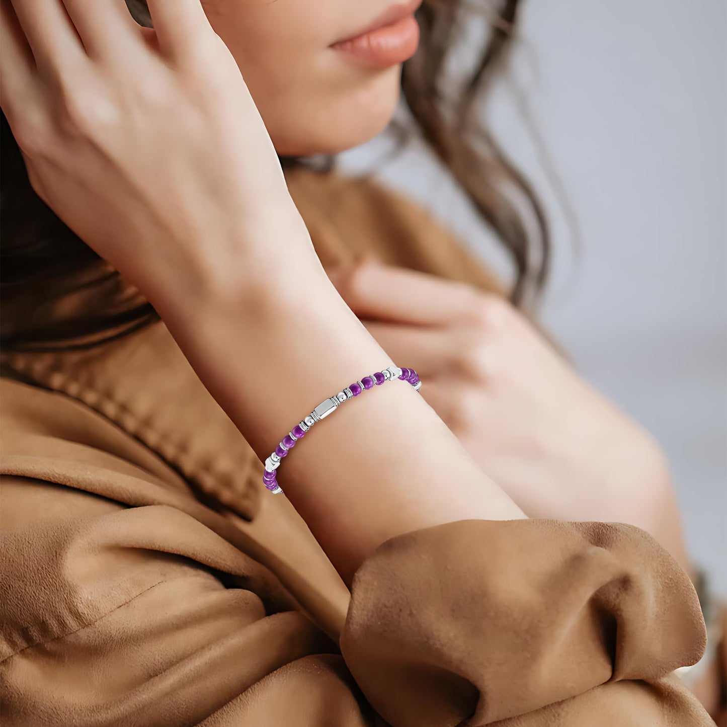 A woman wearing an adjustable boho style amethyst bracelet