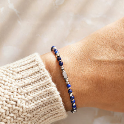 A woman wearing an adjustable boho style Lapis Lazuli energy bracelet.