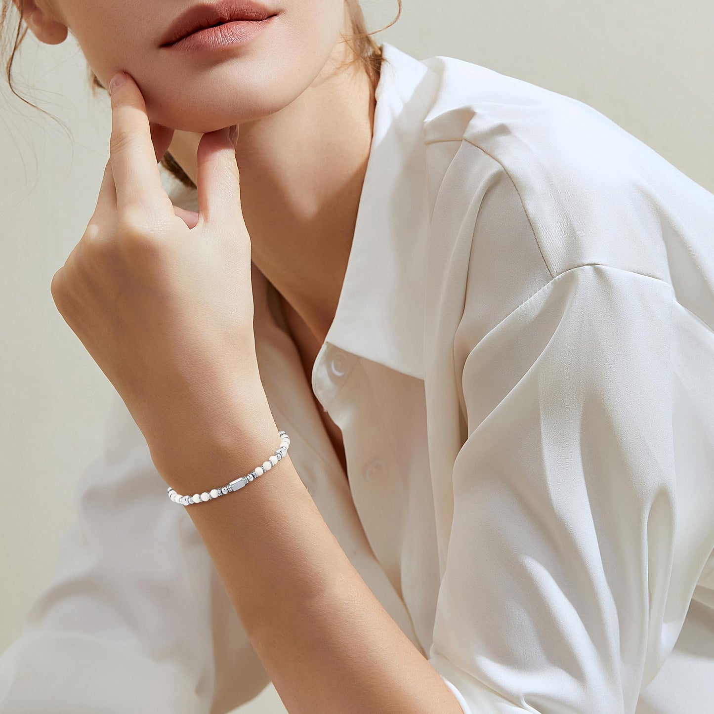 A woman wearing an adjustable boho style Magnesite energy bracelet