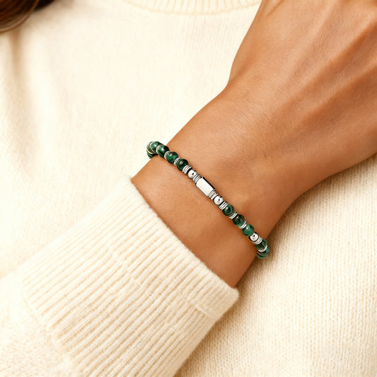 A woman wearing an adjustable boho style Malachite energy bracelet
