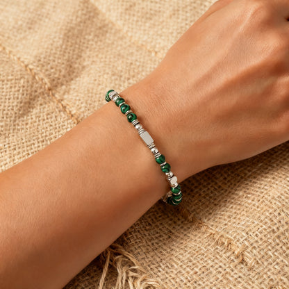 A woman wearing an adjustable boho style Malachite energy bracelet