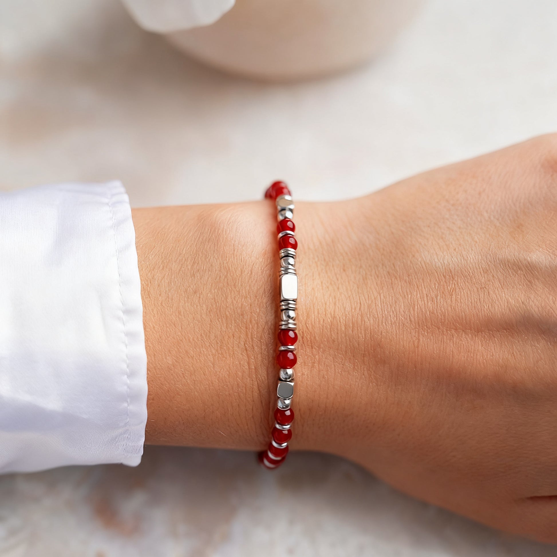 A woman wearing an adjustable boho style Red Agate energy bracelet