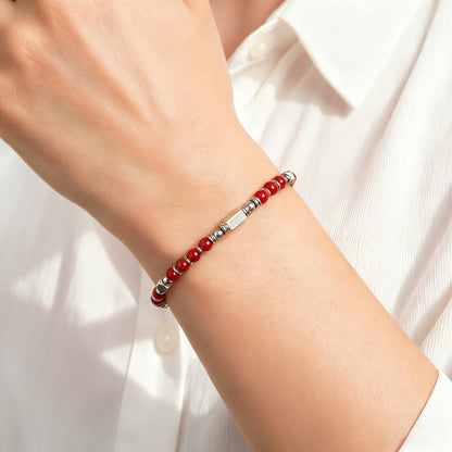 A woman wearing an adjustable boho style Red Agate energy bracelet