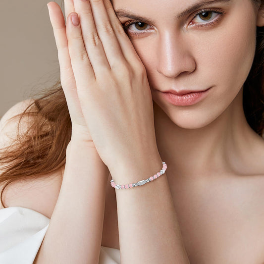 A woman wearing an adjustable boho style rose quartz bracelet