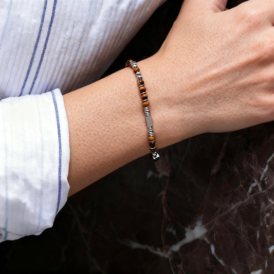 A woman wearing an adjustable boho style Tiger's Eye energy bracelet