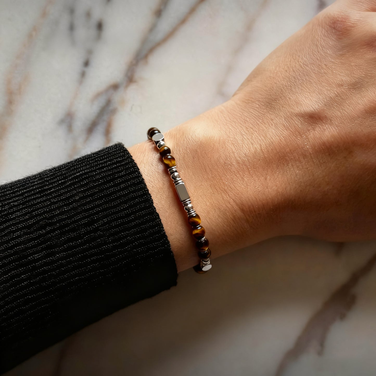 A woman wearing an adjustable boho style Tiger's Eye energy bracelet