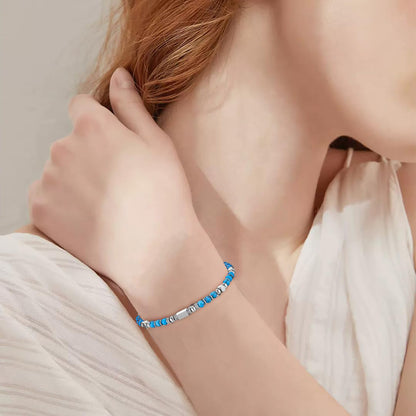 A woman wearing an adjustable boho style turquoise bracelet