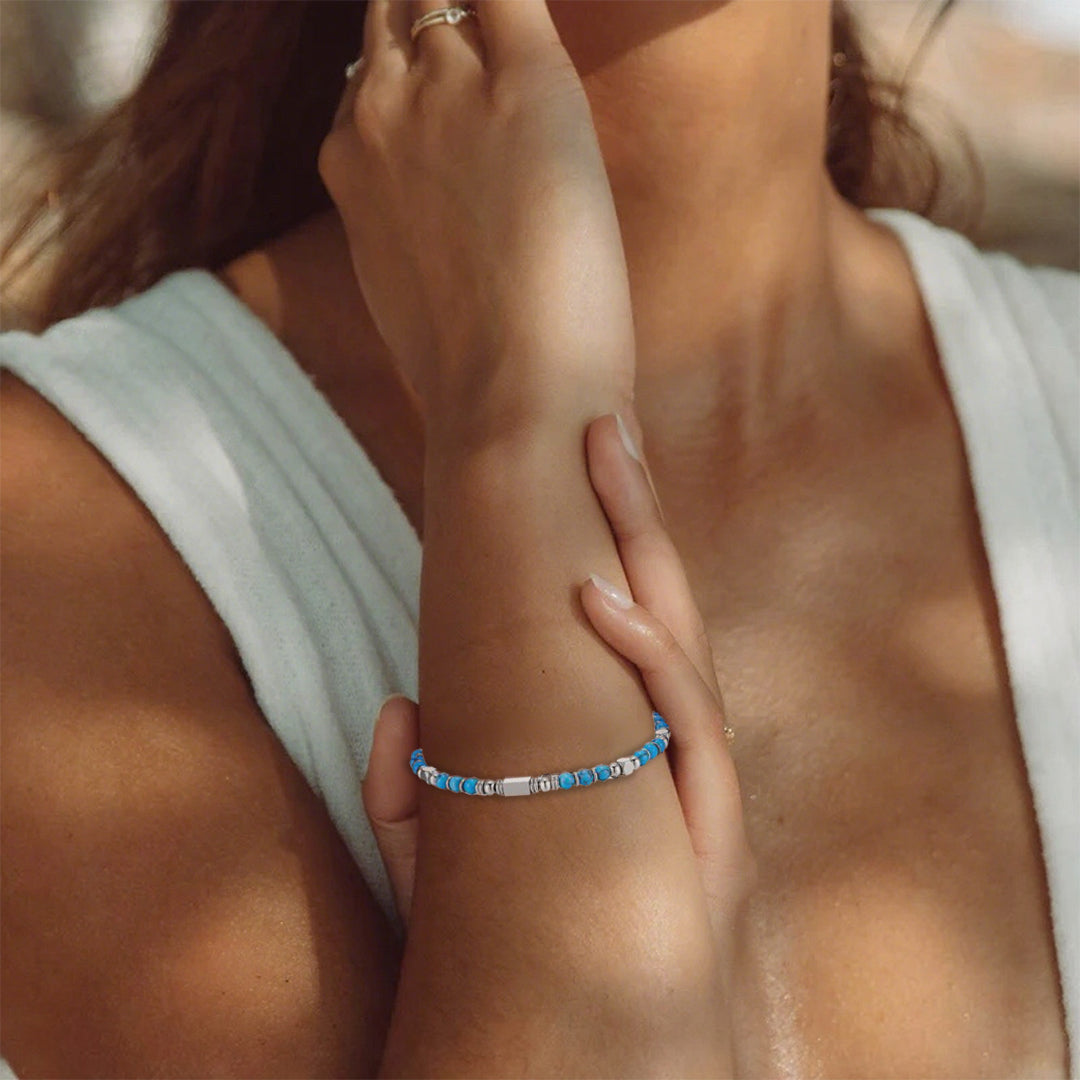 A woman wearing an adjustable boho style Turquoise energy bracelet