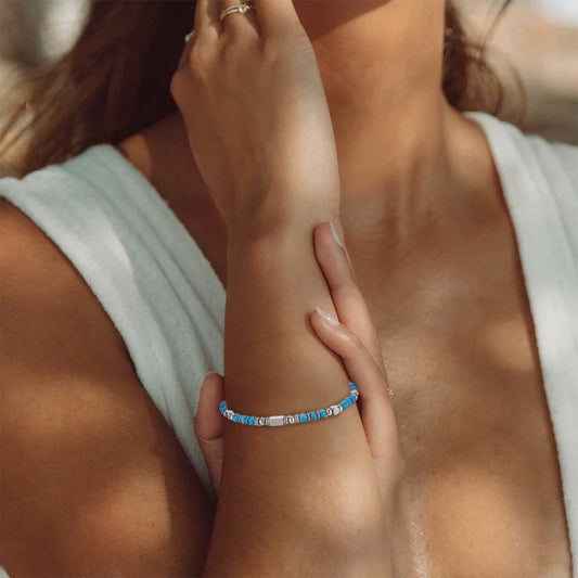 A woman wearing an adjustable boho style Turquoise energy bracelet