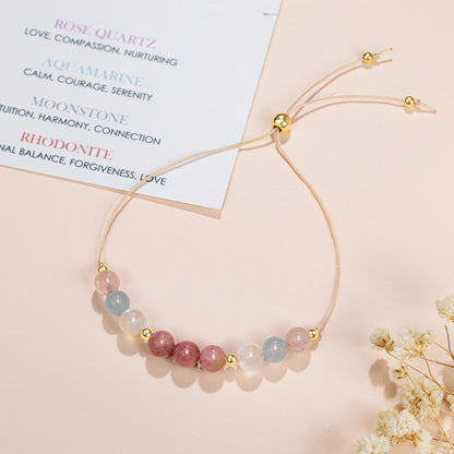 an adjustable beaded energy bracelet with rose quartz, aquamarine, moonstone and rhodonite.
