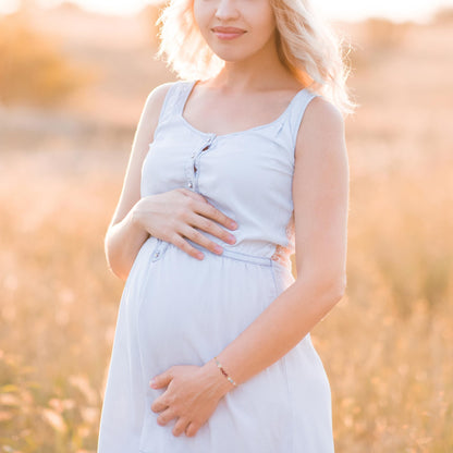 a pregnant woman wearing adjustable beaded energy bracelets with rose quartz, aquamarine, moonstone and rhodonite.